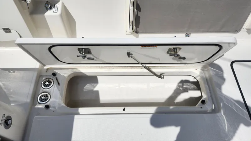 Slide: The Image of Open storage compartment on 2023 Pursuit S 358 Sport boat deck. - 46