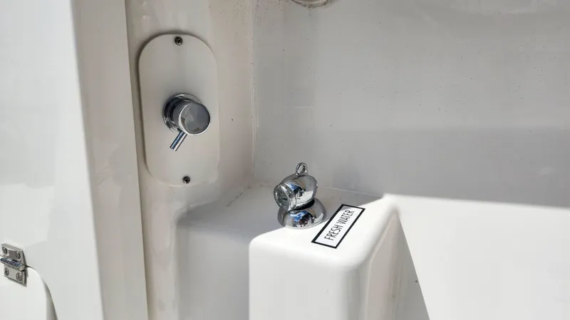 Slide: The Image of Fresh water outlet on 2023 Pursuit S 358 Sport boat. - 47