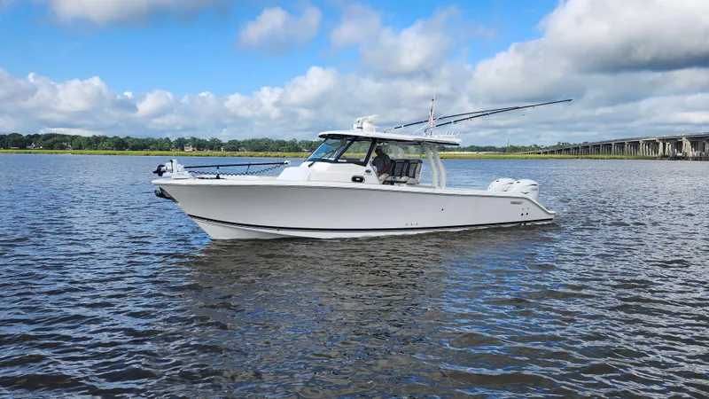 Slide: The Image of 2023 Pursuit S 358 Sport boat on calm water under a cloudy sky. - 5