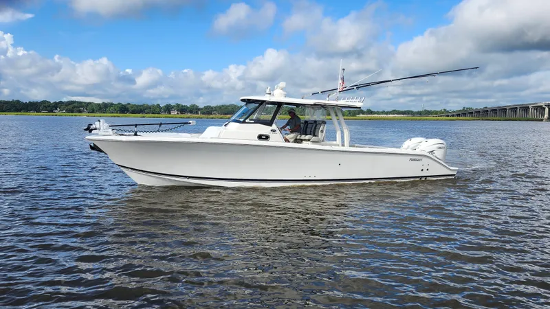 Slide: The Image of 2023 Pursuit S 358 Sport boat cruising on a calm river under a blue sky. - 6