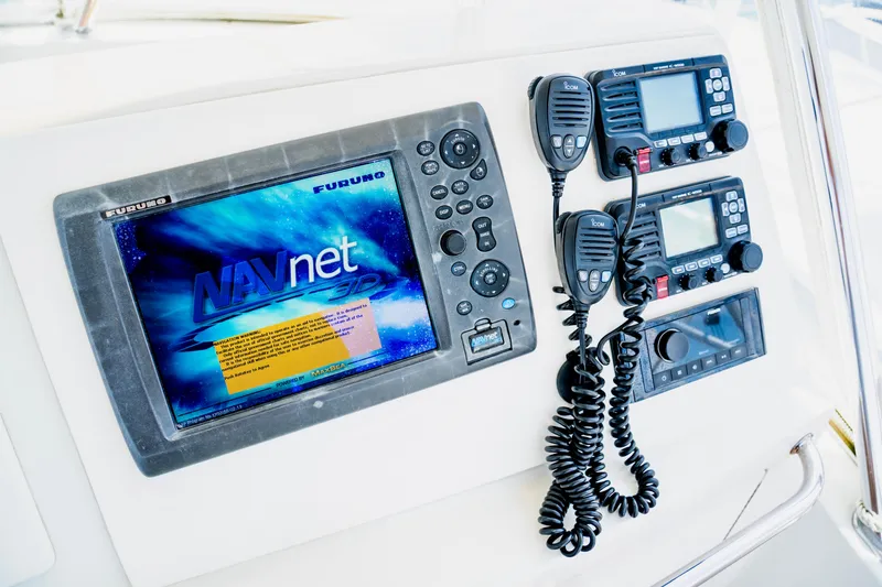 Slide: The Image of Navigation and communication equipment on a 2002 Cabo 47 Flybridge Sportfisher boat. - 10