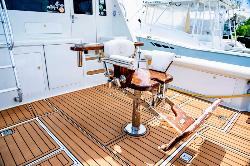 Slide: The Image of 2002 Cabo 47 Flybridge Sportfisher with teak deck and fishing chair. - 16