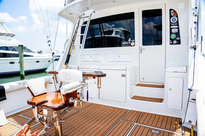 Slide: The Image of 2002 Cabo 47 Flybridge Sportfisher yacht deck with fishing chair and ladder. - 17