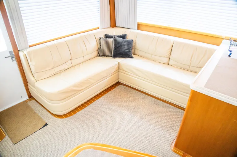 Slide: The Image of Luxurious interior of 2002 Cabo 47 Flybridge Sportfisher with cream leather seating and cushions. - 18