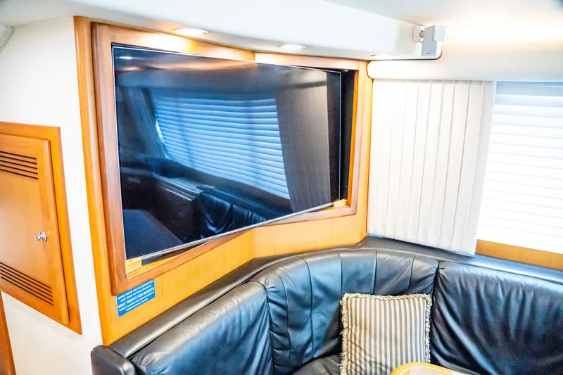 Slide: The Image of Luxurious interior of 2002 Cabo 47 Flybridge Sportfisher with leather seating and mounted TV. - 20