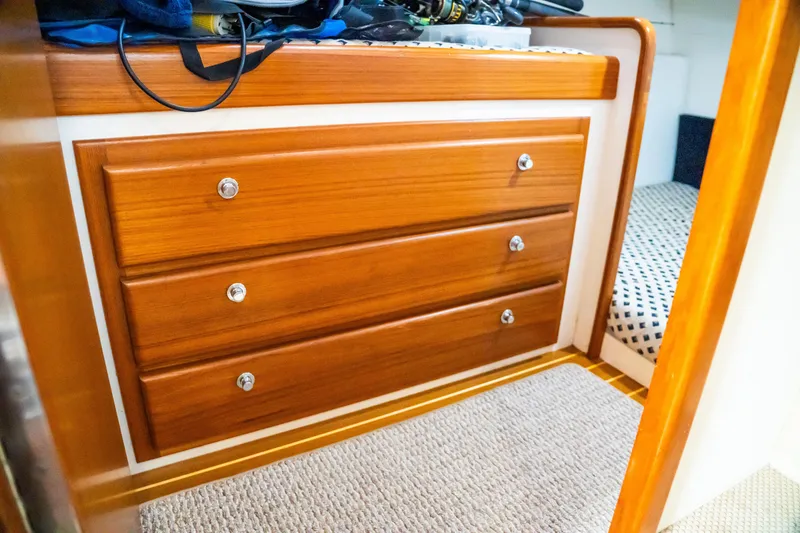 Slide: The Image of Wooden drawers inside a 2002 Cabo 47 Flybridge Sportfisher boat cabin. - 27