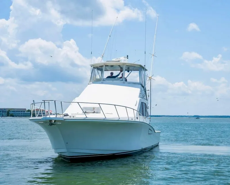 Slide: The Image of 2002 Cabo 47 Flybridge Sportfisher cruising on a sunny day. - 7