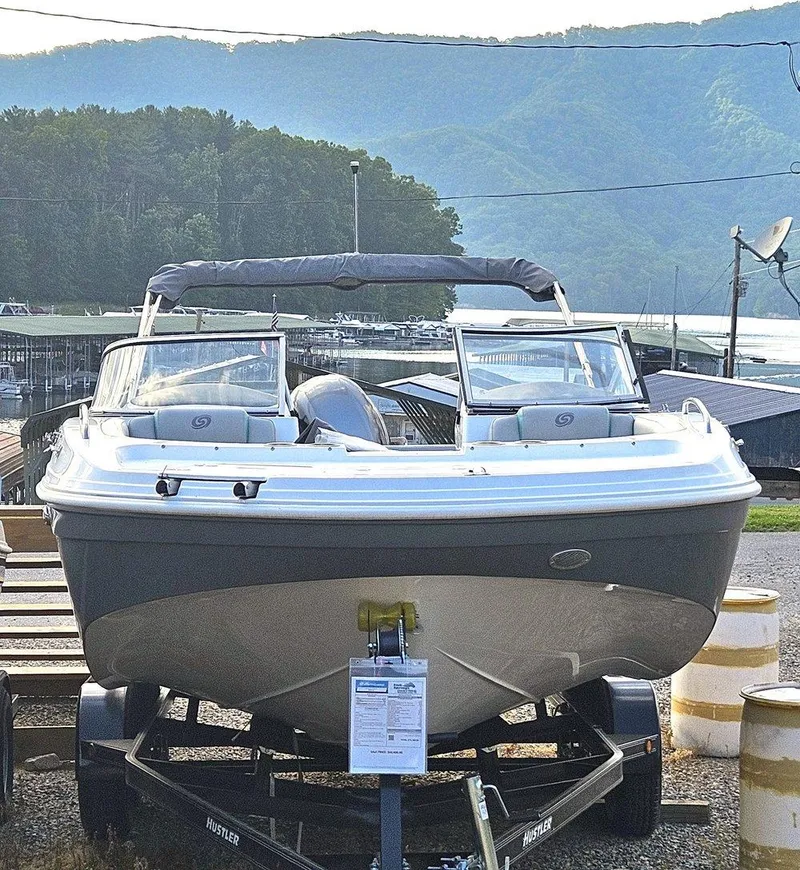 Slide: The Image of 2024 Hurricane SD 191 OB boat on trailer, scenic mountain and lake background. - 2