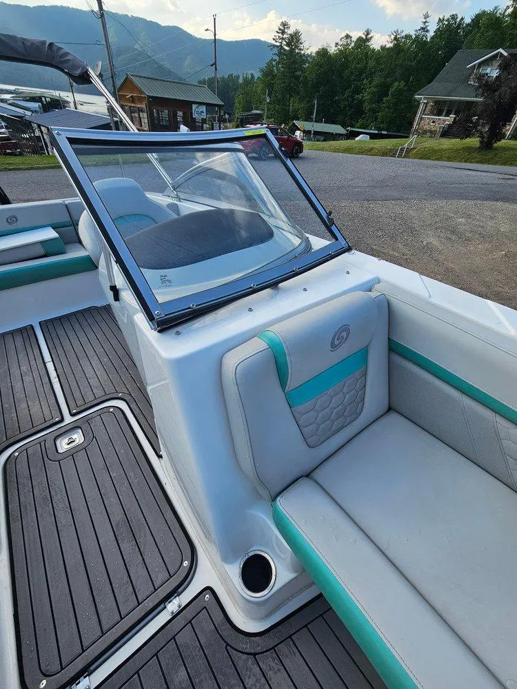 Slide: The Image of 2024 Hurricane SD 191 OB boat interior with seating and windshield, set against a scenic backdrop. - 4