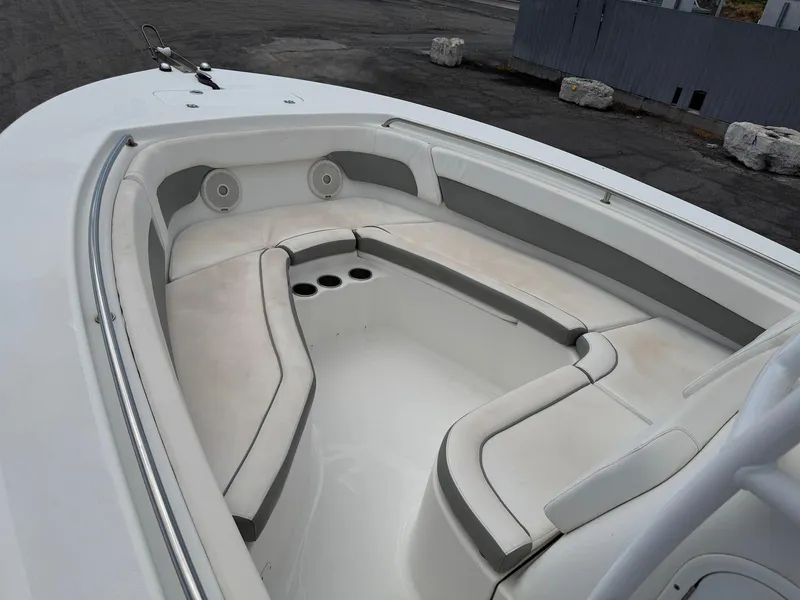 Slide: The Image of 2014 Tidewater 230 LXF boat interior with cushioned seating and cup holders. - 12