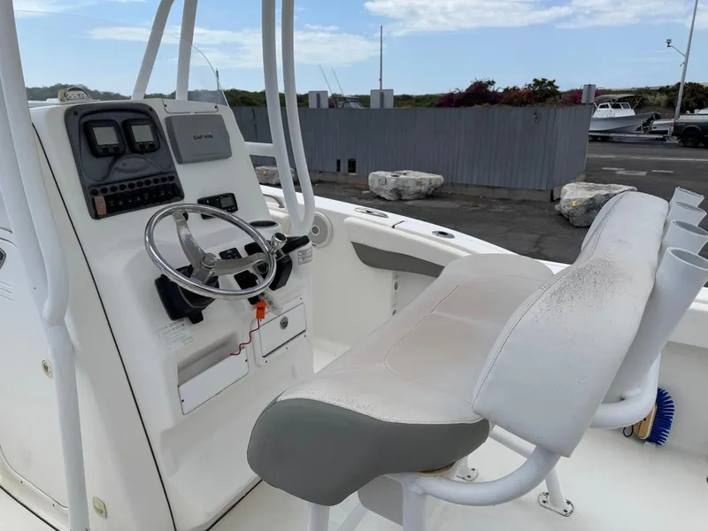 Slide: The Image of 2014 Tidewater 230 LXF boat cockpit with steering wheel and seating. - 13