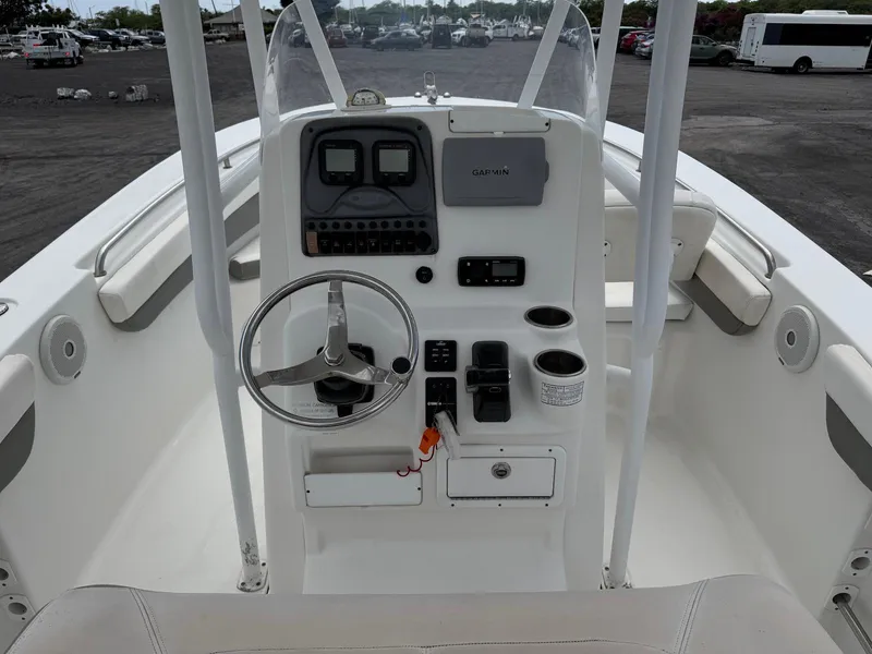 Slide: The Image of 2014 Tidewater 230 LXF boat console with steering wheel and navigation controls. - 15