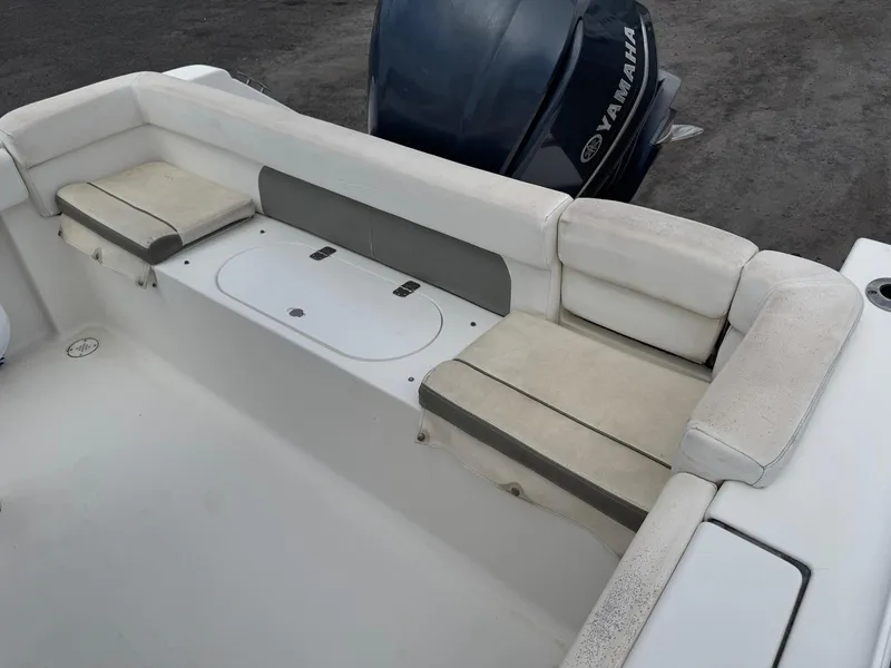 Slide: The Image of 2014 Tidewater 230 LXF boat interior with Yamaha engine, featuring cushioned seating. - 16