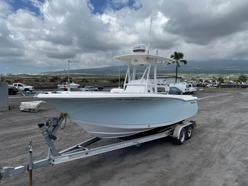 Slide: The Image of 2014 Tidewater 230 LXF boat on trailer, parked outdoors under cloudy sky. - 3