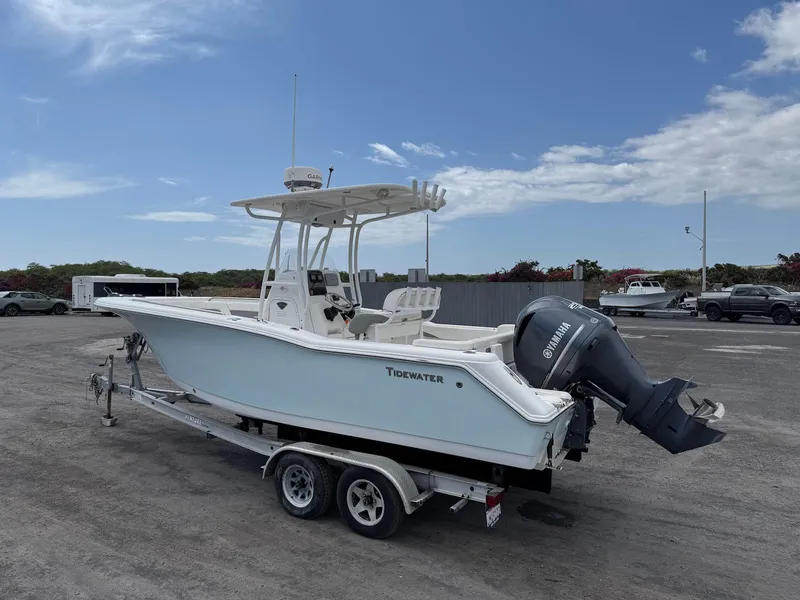 Slide: The Image of 2014 Tidewater 230 LXF boat on trailer with Yamaha outboard motor, parked outdoors. - 5