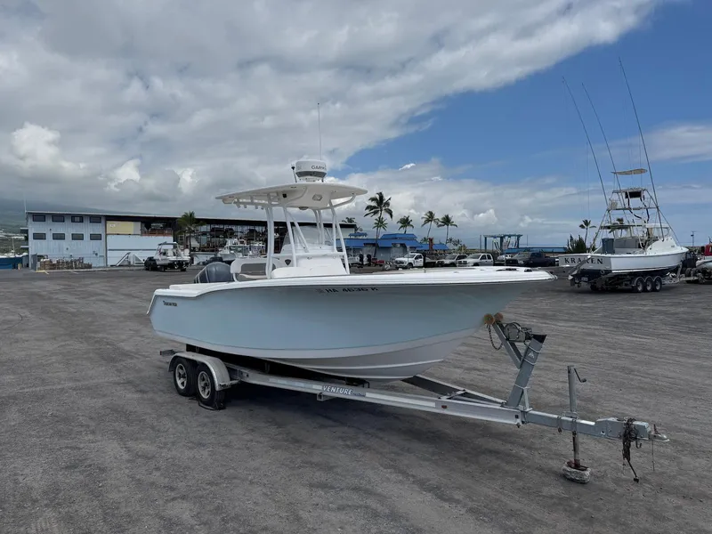 Slide: The Image of 2014 Tidewater 230 LXF boat on trailer in marina with cloudy sky background. - 9