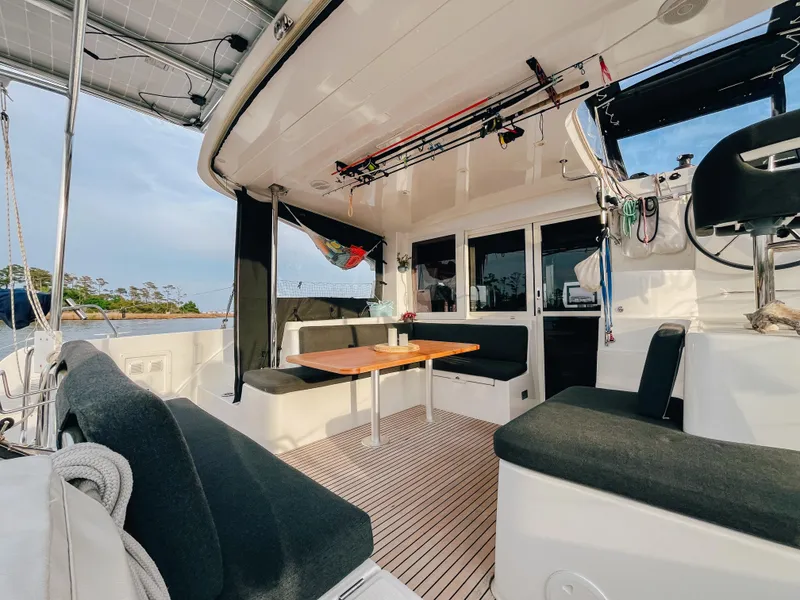 Slide: The Image of Spacious deck of 2023 Lagoon 40 catamaran with seating and table, ideal for relaxation. - 10
