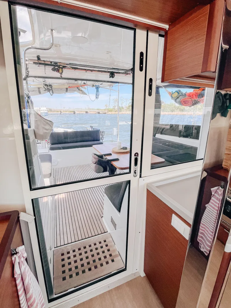 Slide: The Image of Interior view of 2023 Lagoon 40 catamaran, featuring sleek design and spacious deck area. - 13