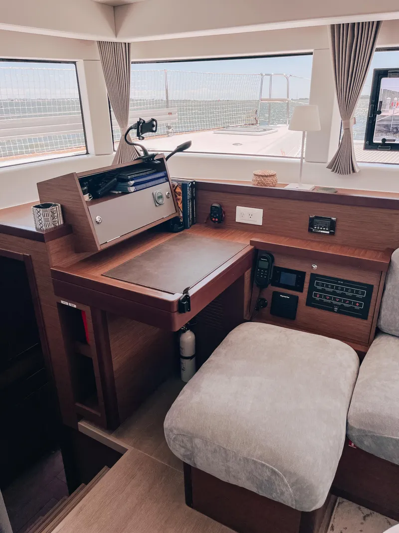 Slide: The Image of 2023 Lagoon 40 yacht interior with navigation station and comfortable seating. - 14