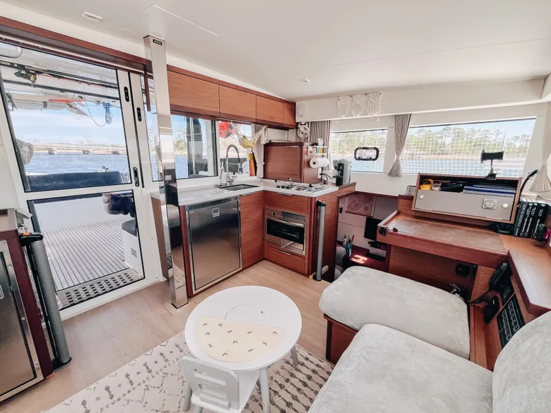 Slide: The Image of Modern interior of 2023 Lagoon 40 catamaran with kitchen, seating, and navigation area. - 15