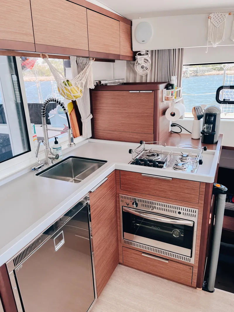 Slide: The Image of Modern kitchen in 2023 Lagoon 40 yacht with stove, oven, and sink. - 16
