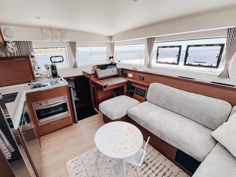 Slide: The Image of Interior of 2023 Lagoon 40 yacht with modern kitchen and cozy seating area. - 17