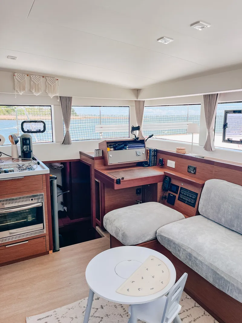 Slide: The Image of Interior of 2023 Lagoon 40 catamaran with modern kitchen and cozy seating area. - 19