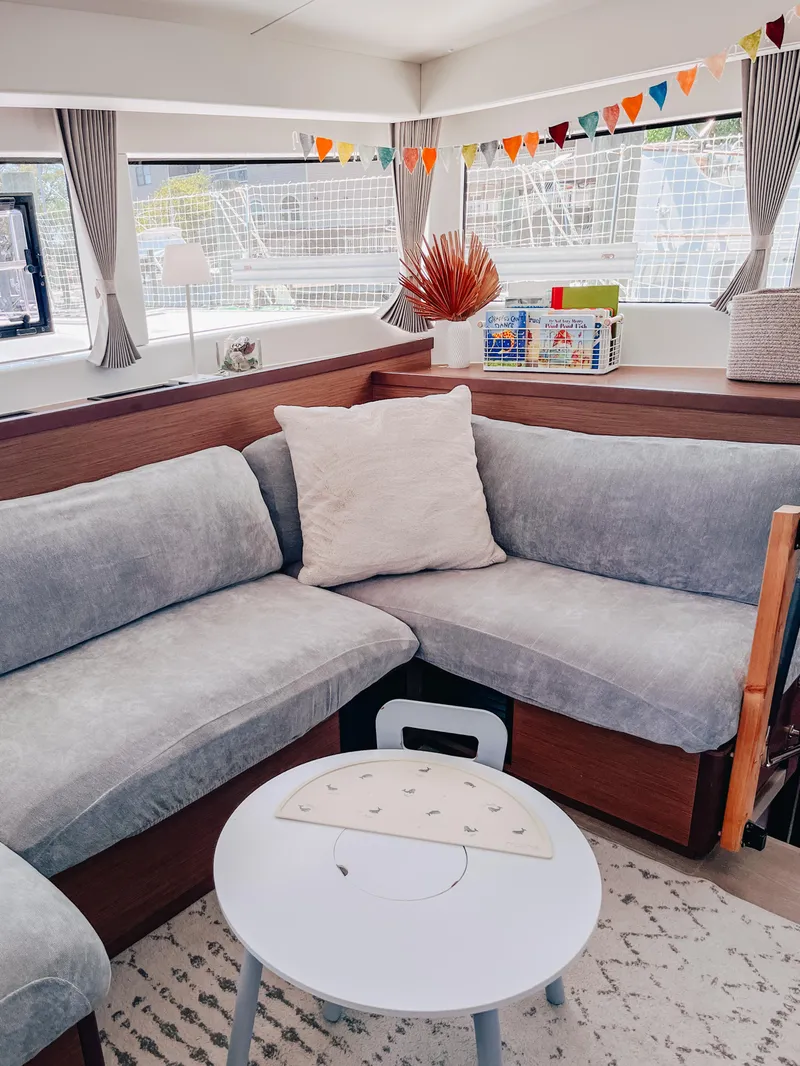 Slide: The Image of Cozy interior of 2023 Lagoon 40 catamaran with plush seating and decorative accents. - 21