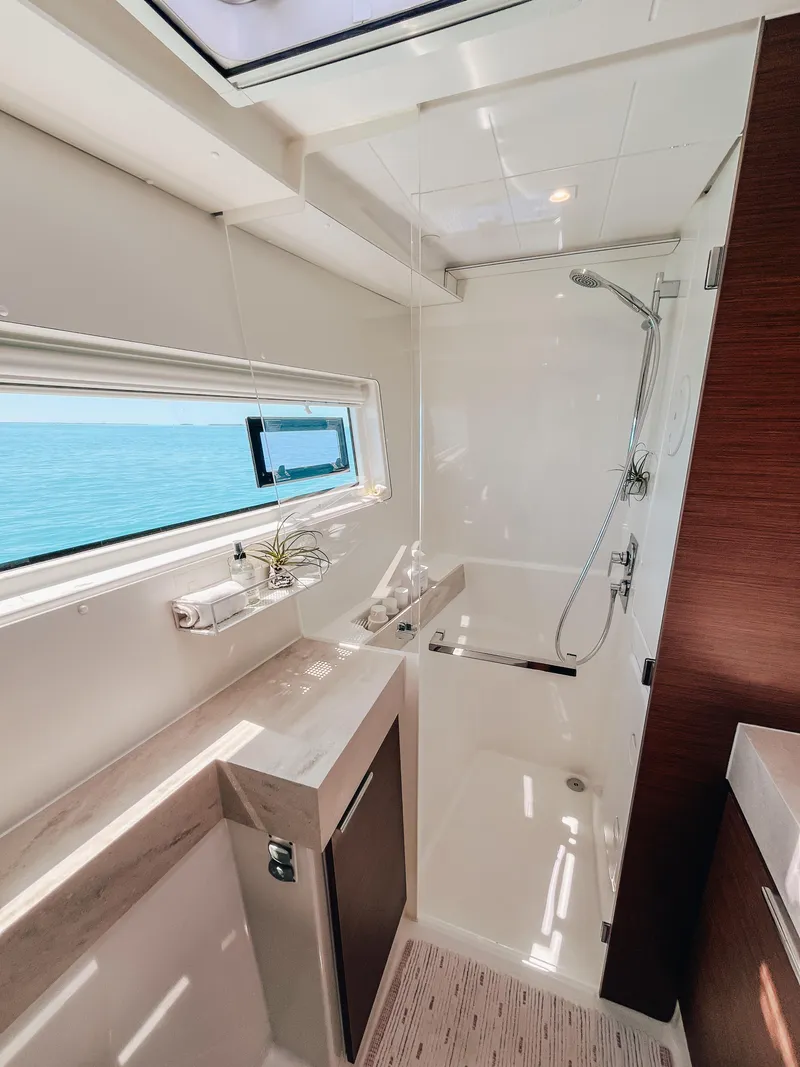 Slide: The Image of Modern bathroom interior on 2023 Lagoon 40 yacht with ocean view window. - 24