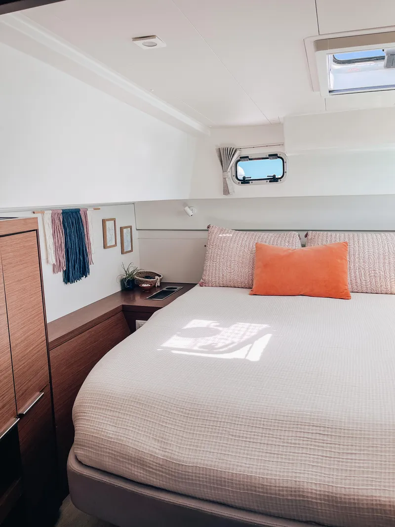 Slide: The Image of 2023 Lagoon 40 yacht cabin interior with cozy bed and modern decor. - 27