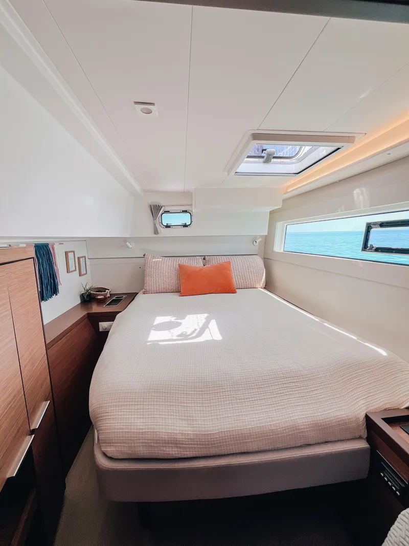 Slide: The Image of Luxurious cabin interior of 2023 Lagoon 40 catamaran with cozy bed and modern decor. - 28