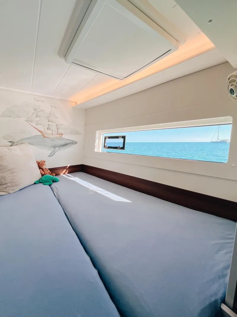 Slide: The Image of Cozy cabin interior of 2023 Lagoon 40 catamaran with ocean view and nautical decor. - 32