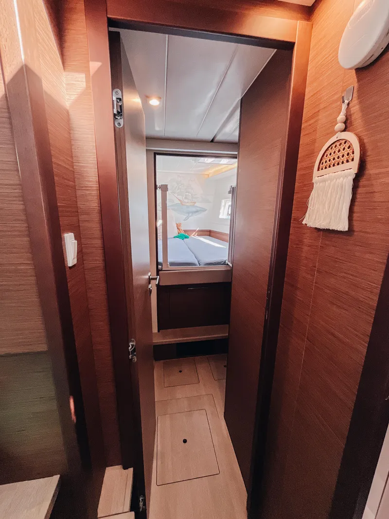 Slide: The Image of Interior view of 2023 Lagoon 40 yacht cabin with wooden finish and cozy decor. - 35