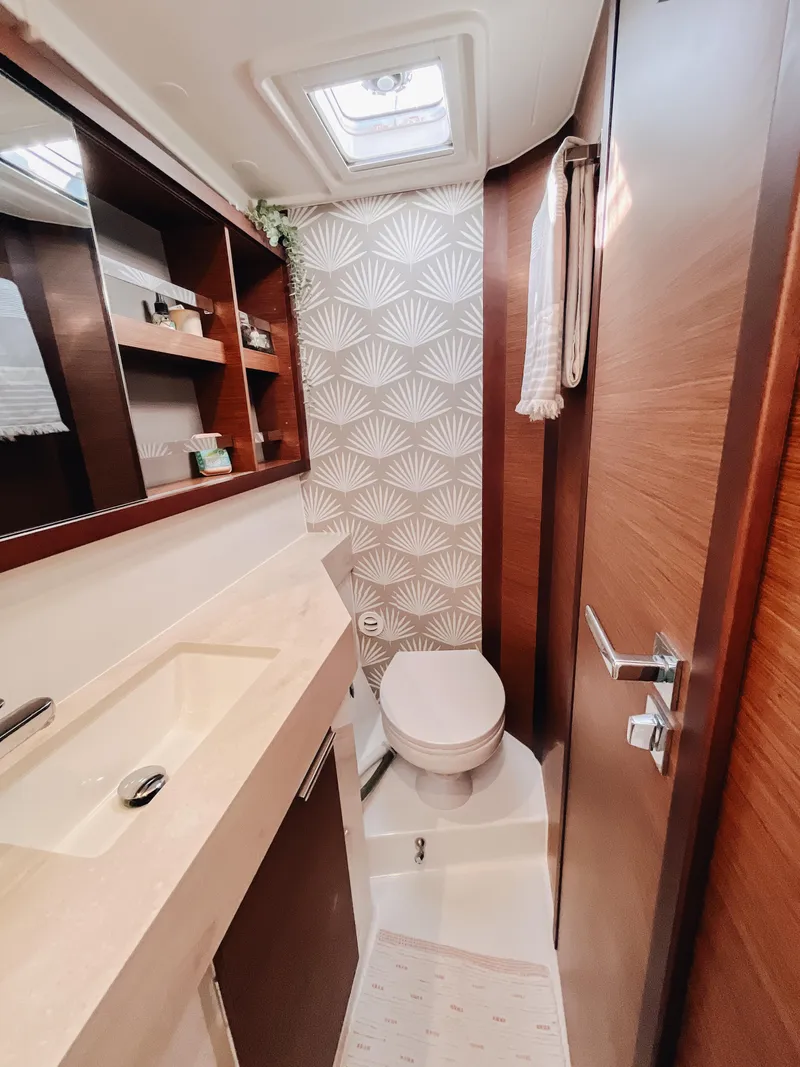 Slide: The Image of Modern bathroom in 2023 Lagoon 40 yacht with elegant wood finish and stylish wallpaper. - 37