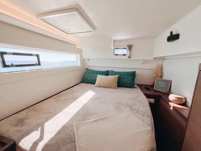 Slide: The Image of Luxurious cabin interior of 2023 Lagoon 40 catamaran with ocean view and cozy bedding. - 39