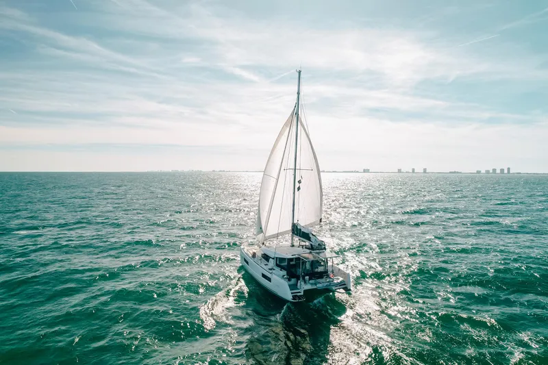 Slide: The Image of Sailing Lagoon 40 catamaran on open sea, 2023 model, under clear sky. - 4