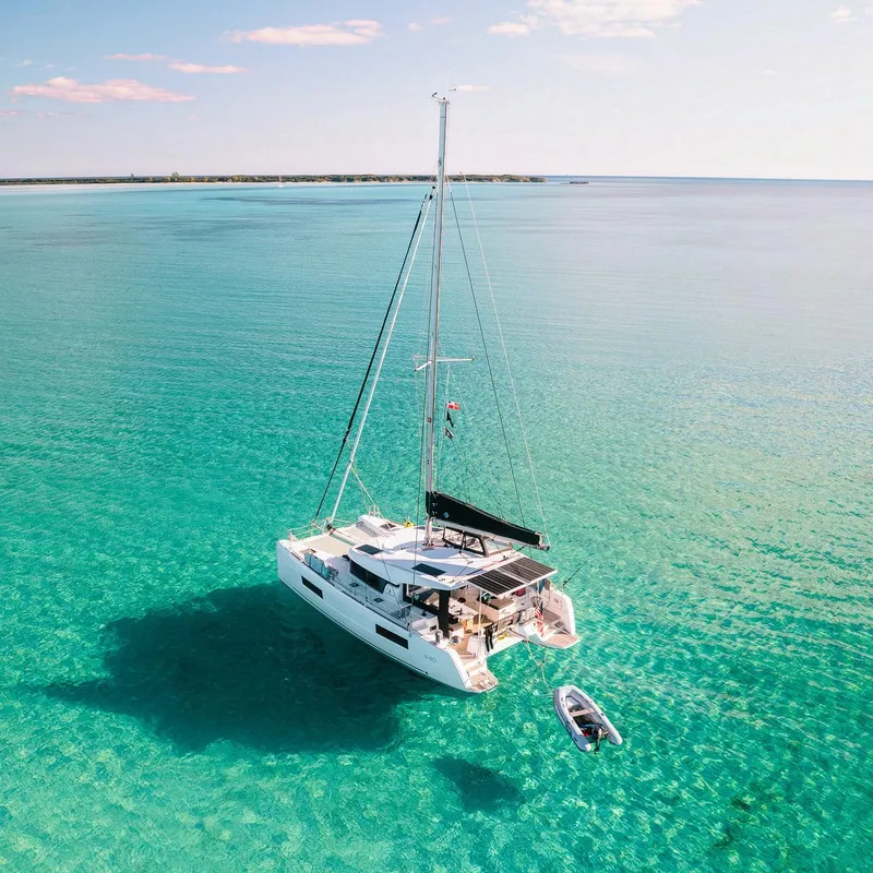 Slide: The Image of 2023 Lagoon 40 catamaran sailing on clear turquoise waters. - 5