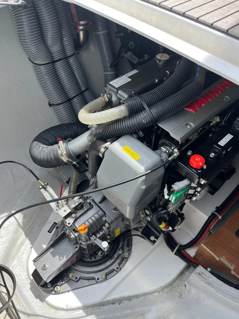 Slide: The Image of Engine compartment of a 2023 Lagoon 40 catamaran, showcasing mechanical components and hoses. - 56