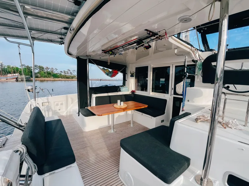 Slide: The Image of 2023 Lagoon 40 catamaran with spacious outdoor seating and dining area on deck. - 6