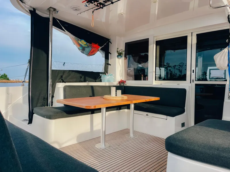 Slide: The Image of 2023 Lagoon 40 yacht interior with cozy seating and wooden table. - 9