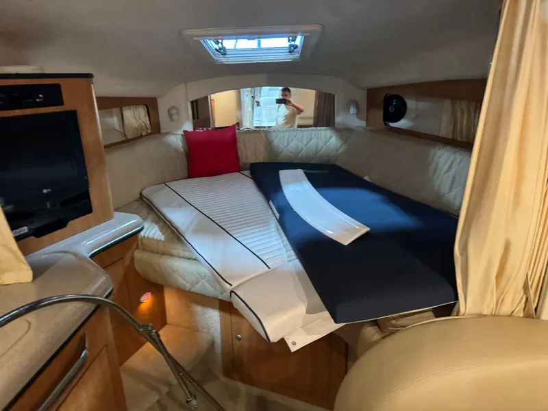 Slide: The Image of Interior cabin of 2005 Sea Ray 300 Sundancer with seating and TV. - 15