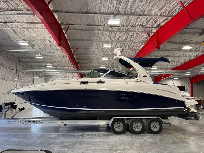 Slide: The Image of 2005 Sea Ray 300 Sundancer boat on trailer in indoor storage facility. - 19