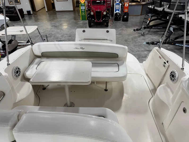Slide: The Image of 2005 Sea Ray 300 Sundancer boat interior with seating and table in showroom. - 6