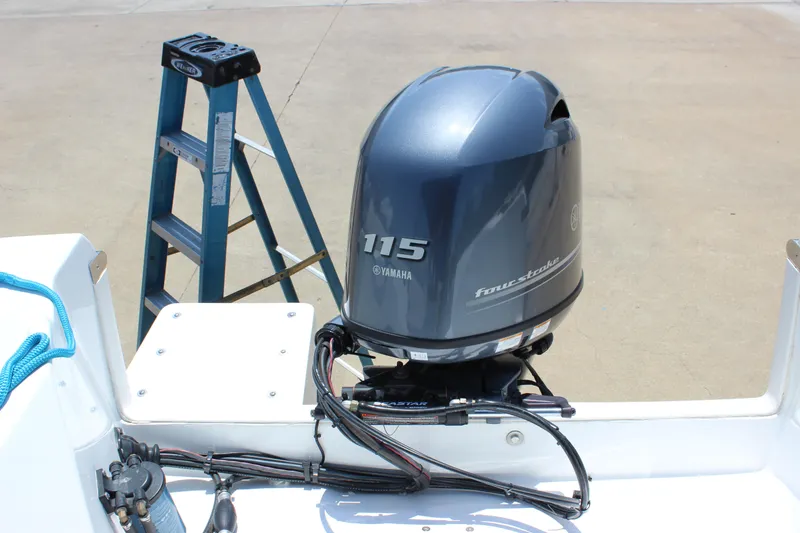 Slide: The Image of 2023 C-Dory 22' Cruiser with Yamaha 115 outboard motor and ladder in background. - 10