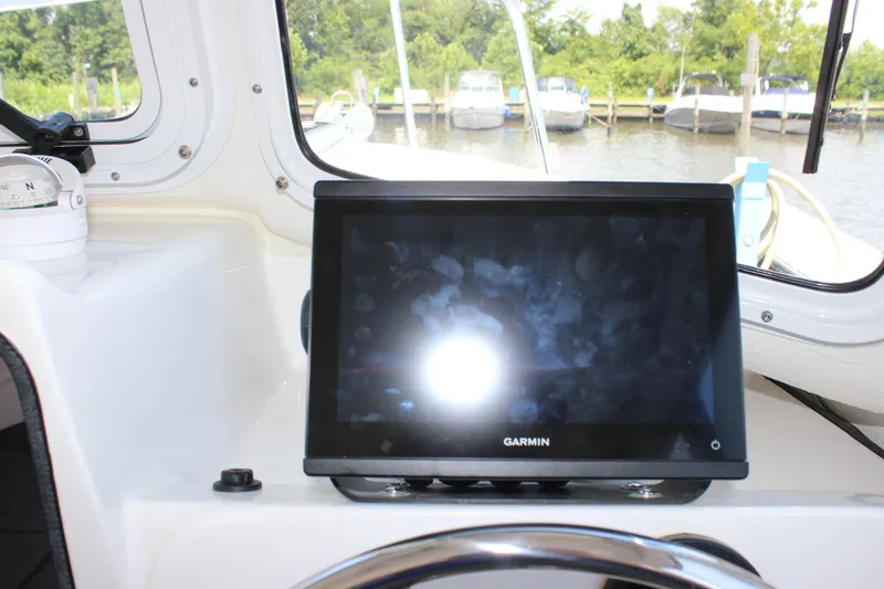 Slide: The Image of Garmin navigation system on 2023 C-Dory 22' Cruiser boat dashboard, docked at marina. - 15