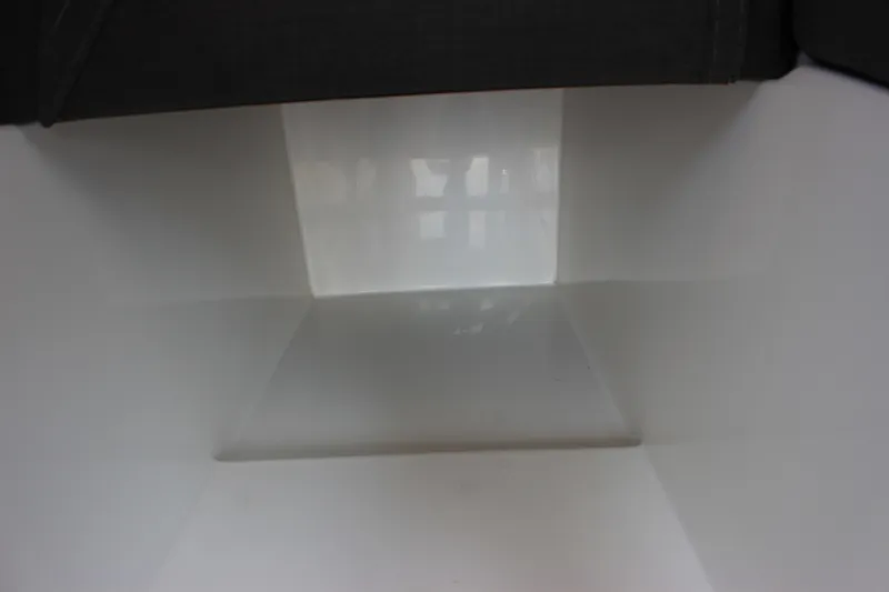 Slide: The Image of Interior view of a 2023 C-Dory 22' Cruiser boat, featuring sleek white surfaces. - 18