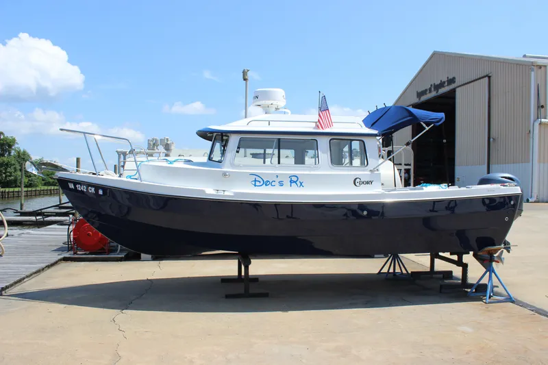 Slide: The Image of 2023 C-Dory 22' Cruiser boat on display at a marina, sunny day. - 3