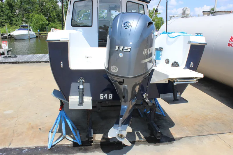 Slide: The Image of 2023 C-Dory 22' Cruiser with Yamaha 115 outboard motor at dockside. - 6