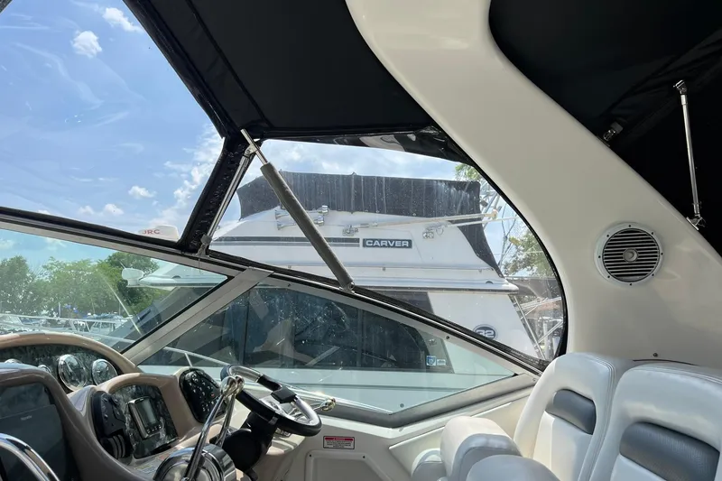 Slide: The Image of Interior view of 2003 Sea Ray 320 Sundancer boat cockpit with steering wheel. - 10
