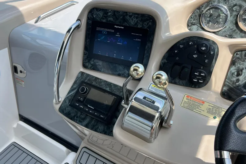 Slide: The Image of Control panel of a 2003 Sea Ray 320 Sundancer boat with navigation equipment. - 12